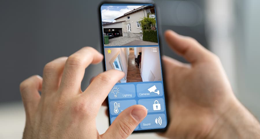 Resident looking at video camera feeds on a cell phone