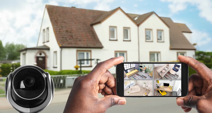 Man holding smartphone and checking streams from video cameras